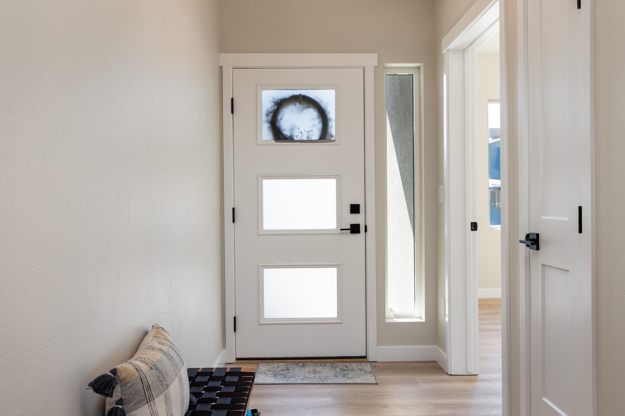 2956 Apollo Drive Grand Junction, CO 81504 - Photo 11 of 33 a hallway with front door wooden floor and windows