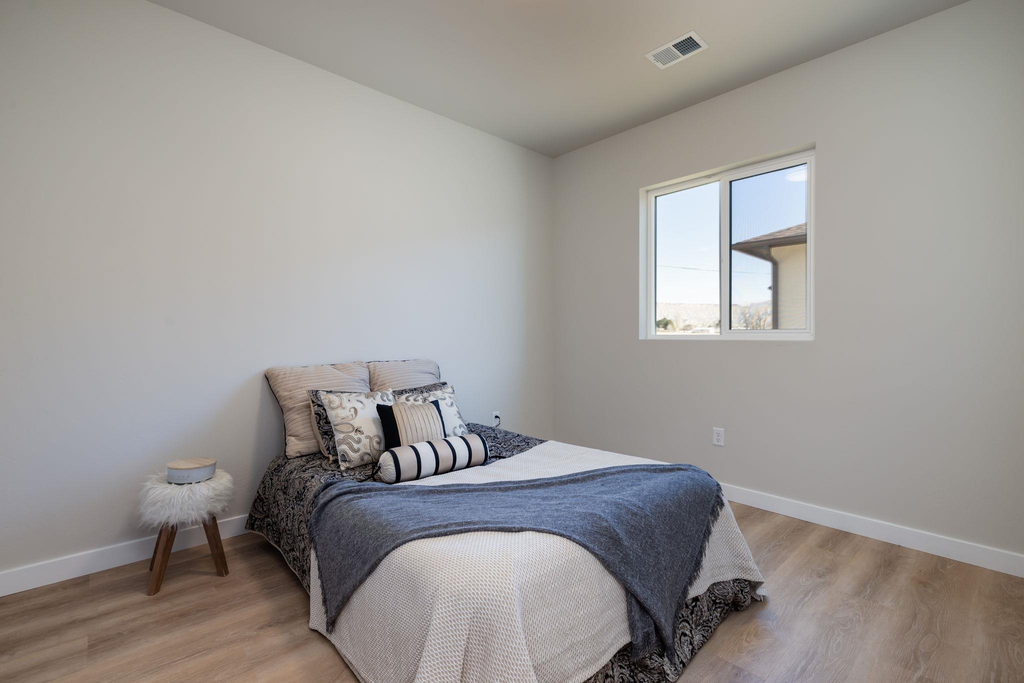 2956 Apollo Drive Grand Junction, CO 81504 - Photo 24 of 33 a bedroom with a bed and wooden floor