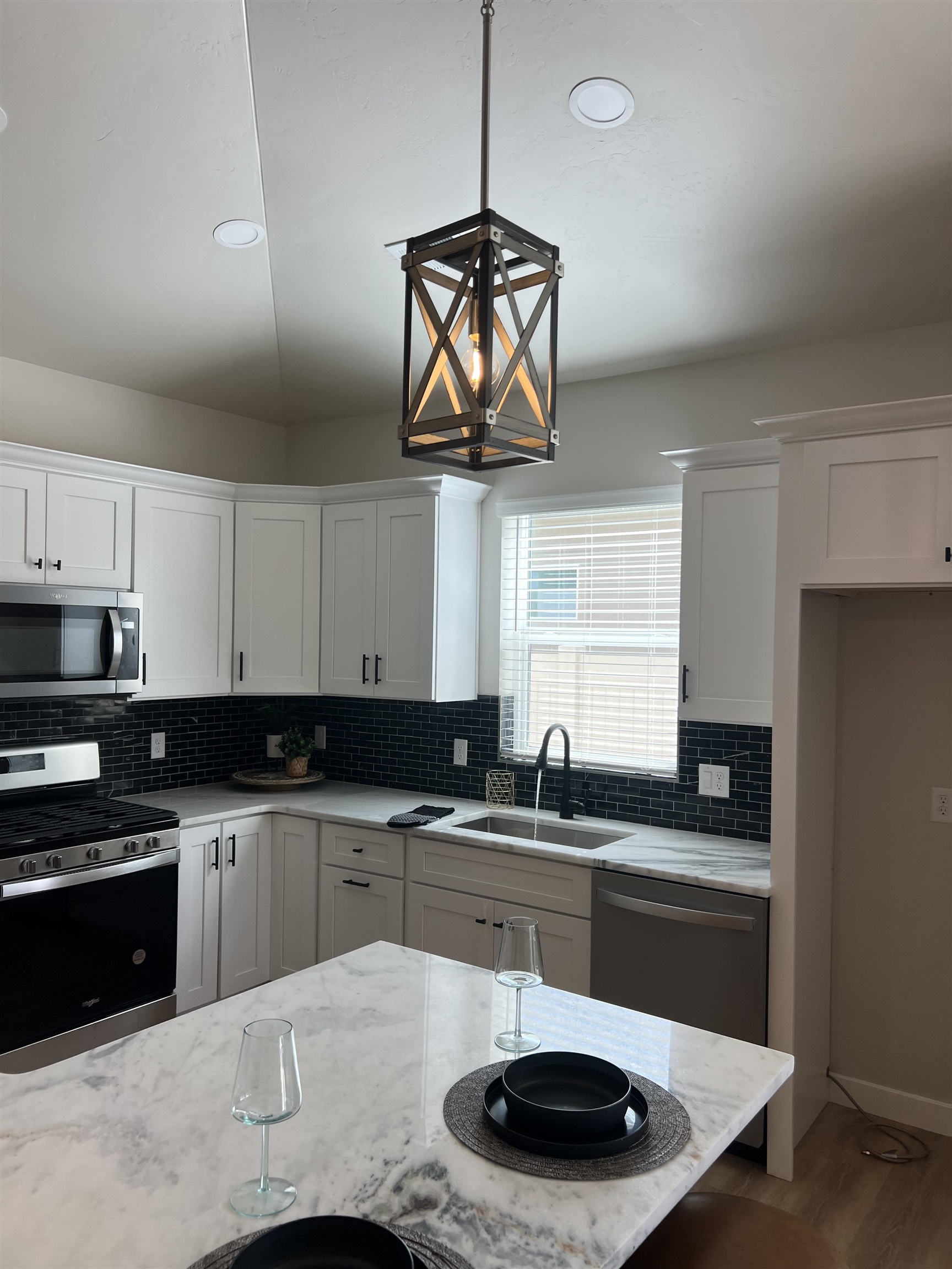 2956 Apollo Drive Grand Junction, CO 81504 - Photo 27 of 33 a kitchen with stainless steel appliances granite countertop a sink a stove a microwave a counter space and cabinets