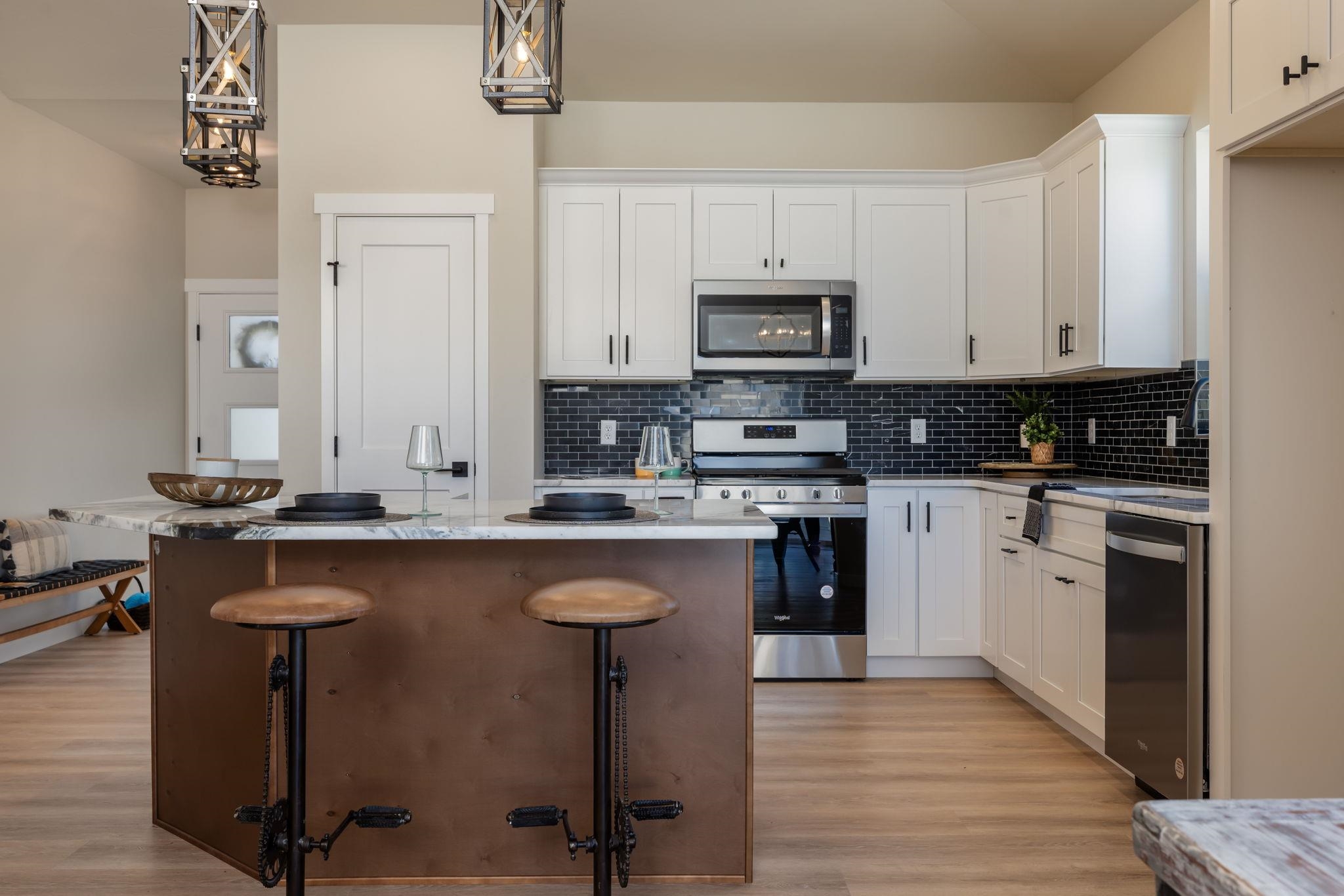 2956 Apollo Drive Grand Junction, CO 81504 - Photo 3 of 33 a kitchen with stainless steel appliances granite countertop a stove top oven a sink and white cabinets