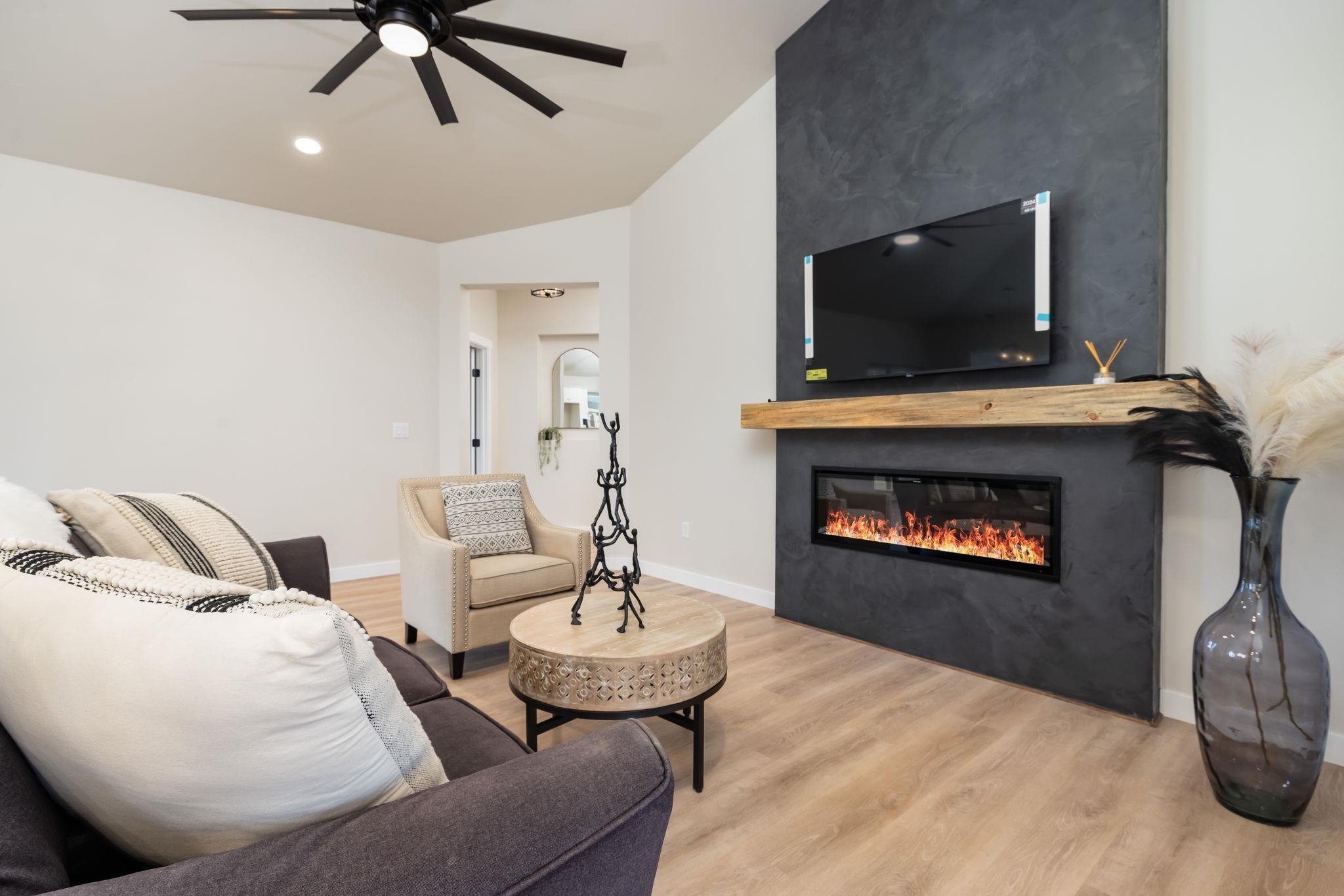 2956 Apollo Drive Grand Junction, CO 81504 - Photo 4 of 33 a living room with furniture a flat screen tv and a fireplace