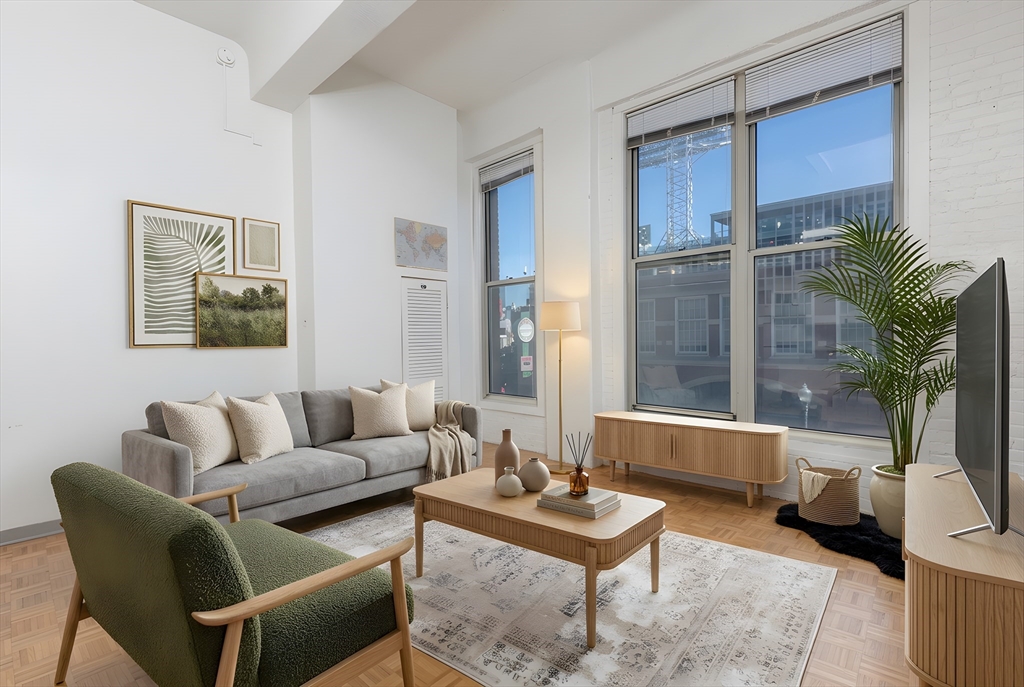61 Brookline Avenue, Unit 214 Boston, MA 02215 - Photo 2 of 7 a living room with furniture and a potted plant