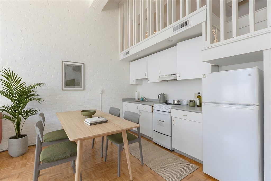 61 Brookline Avenue, Unit 214 Boston, MA 02215 - Photo 3 of 7 a kitchen with white cabinets and refrigerator
