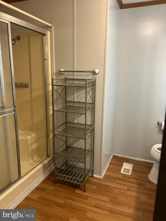 a bathroom with a shower a toilet and a shower