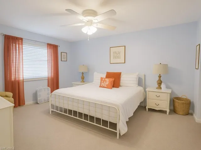 a bedroom with bed and a chandelier