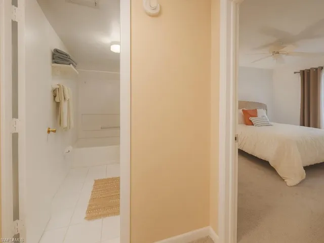 a bedroom with a bed and a mirror