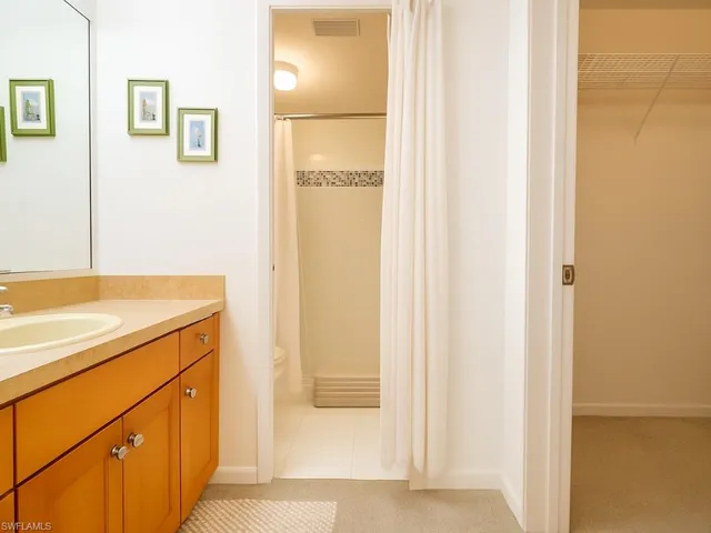 a bathroom with a shower and a sink