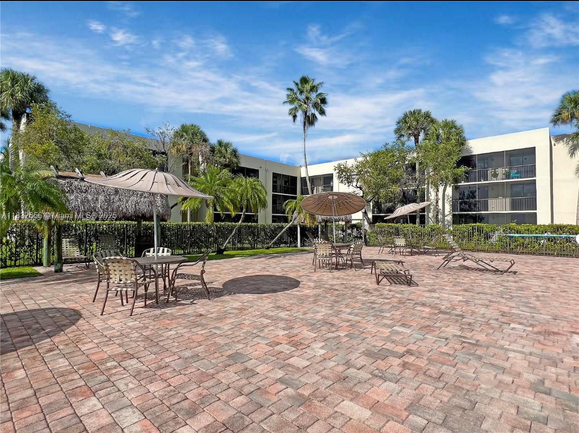 Kendall Miami, FL 33173 - Photo 14 of 20 a view of a patio with a table and chairs under an umbrella