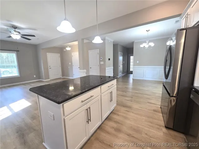 a kitchen with stainless steel appliances granite countertop a sink and a refrigerator