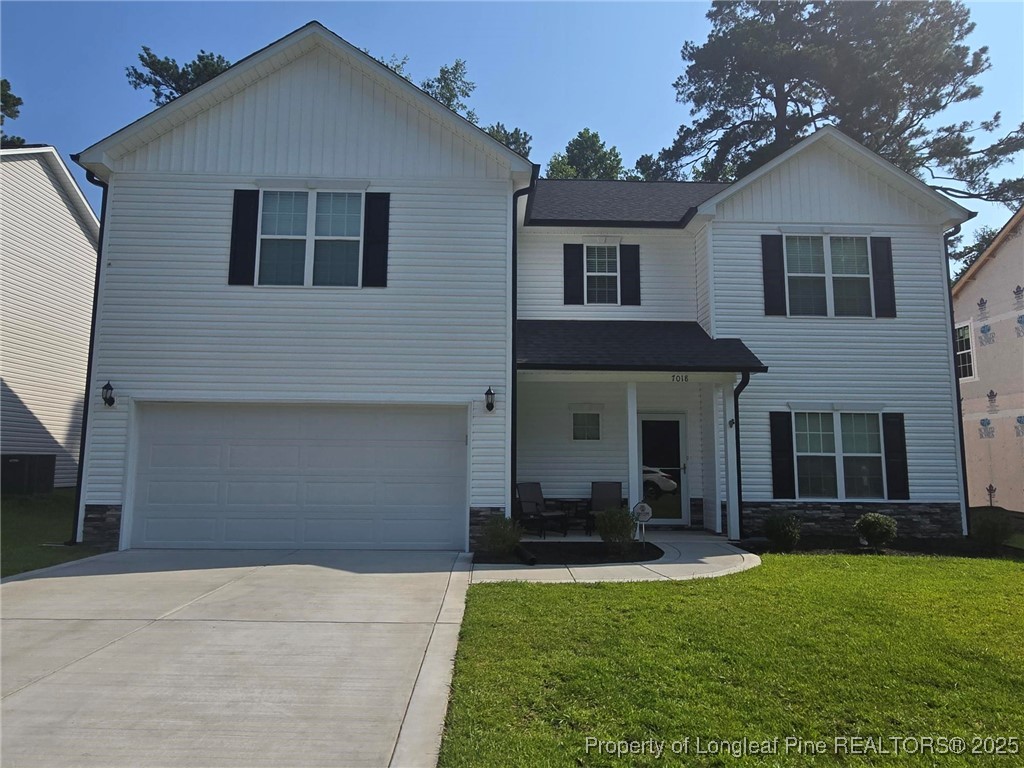 7018 Summerlin Drive Fayetteville, NC 28306 - Photo 2 of 39 a front view of a house with a yard and garage