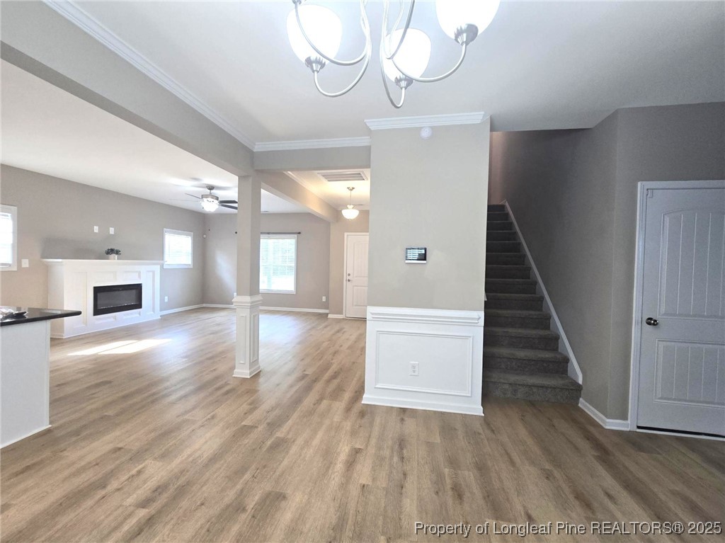 7018 Summerlin Drive Fayetteville, NC 28306 - Photo 23 of 39 a view of a hallway with wooden floor and staircase