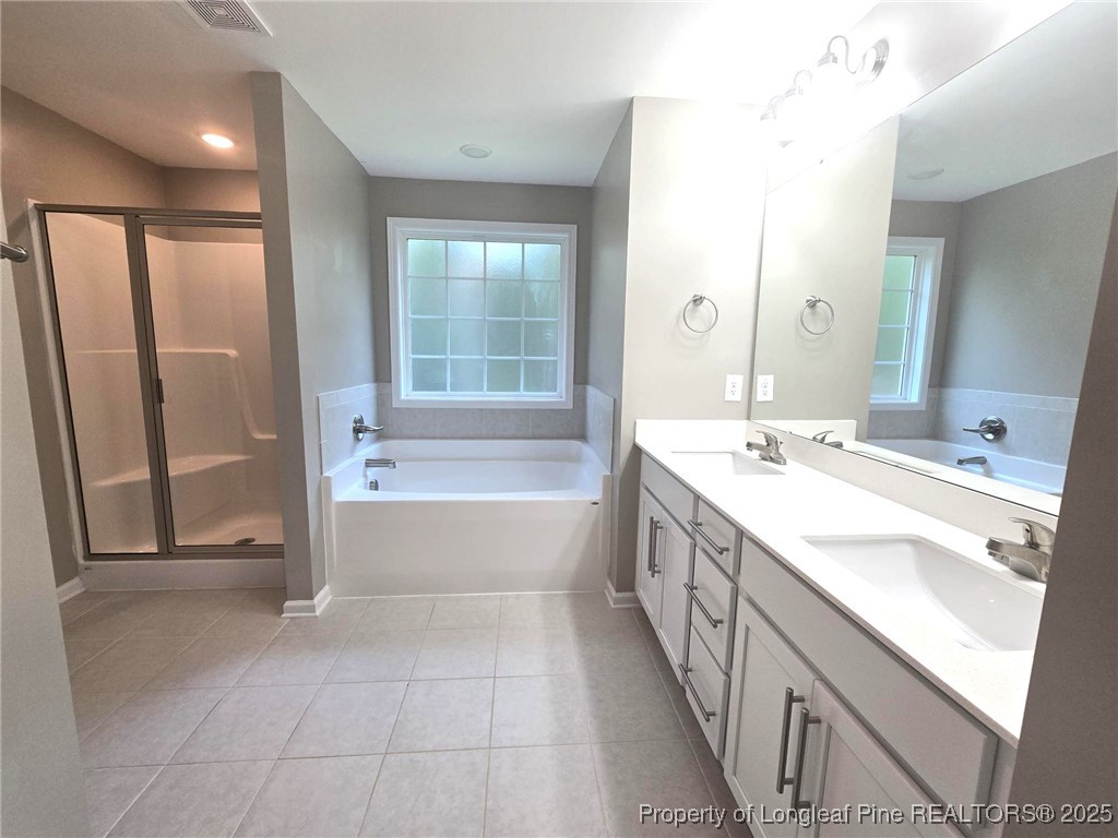 7018 Summerlin Drive Fayetteville, NC 28306 - Photo 29 of 39 a spacious bathroom with a tub sink and mirror