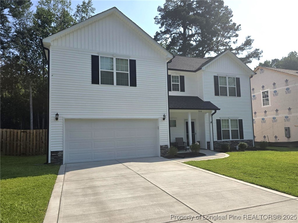 7018 Summerlin Drive Fayetteville, NC 28306 - Photo 3 of 39 a front view of a house with a yard and garage