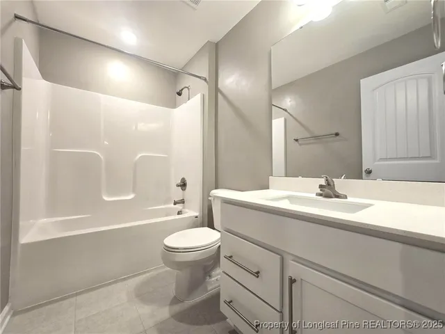 a bathroom with a sink toilet double vanity and shower