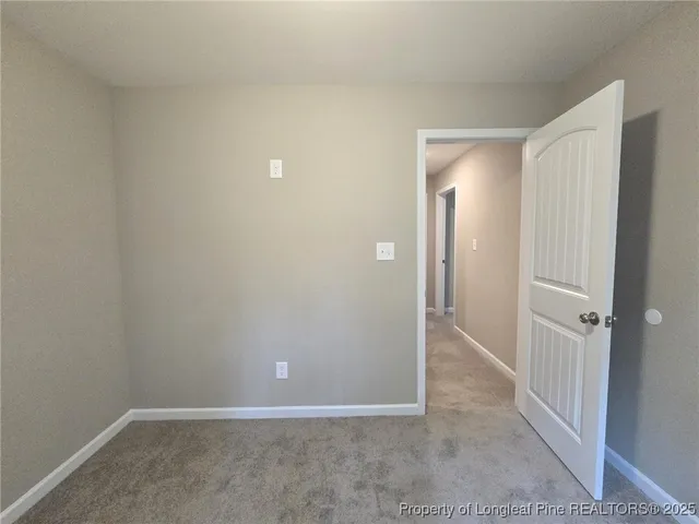an empty room with closet and mirror