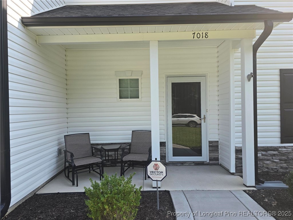 7018 Summerlin Drive Fayetteville, NC 28306 - Photo 5 of 39 a view of a chairs and table in the back yard
