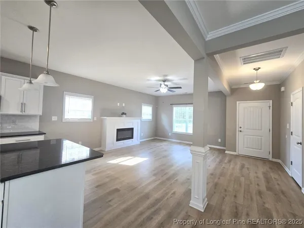 a view of a kitchen with a sink dishwasher and fireplace