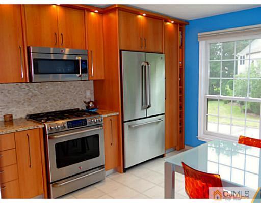 3403 Springbrook Drive Edison, NJ 08820 - Photo 2 of 24 a kitchen with stainless steel appliances granite countertop a stove microwave and refrigerator