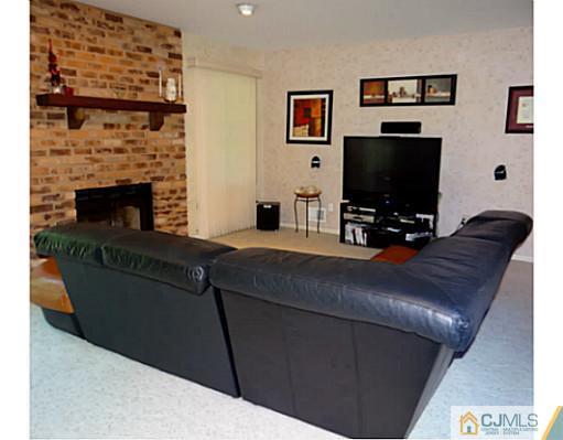 3403 Springbrook Drive Edison, NJ 08820 - Photo 11 of 24 a living room with furniture and a flat screen tv