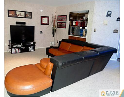3403 Springbrook Drive Edison, NJ 08820 - Photo 12 of 24 a room with furniture and a flat screen tv