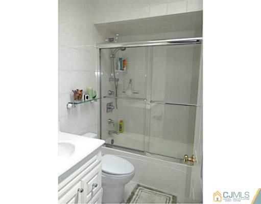 3403 Springbrook Drive Edison, NJ 08820 - Photo 15 of 24 a bathroom with a granite countertop bathtub shower sink vanity and toilet