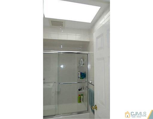 3403 Springbrook Drive Edison, NJ 08820 - Photo 16 of 24 a bathroom with a glass shower door