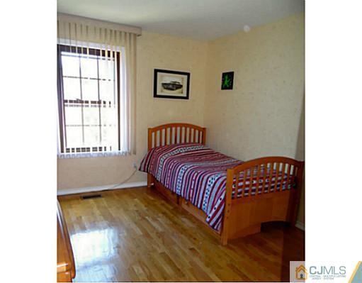 3403 Springbrook Drive Edison, NJ 08820 - Photo 18 of 24 a bedroom with bed and a window