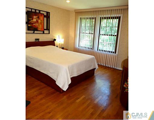 3403 Springbrook Drive Edison, NJ 08820 - Photo 19 of 24 a bedroom with a bed and a large window