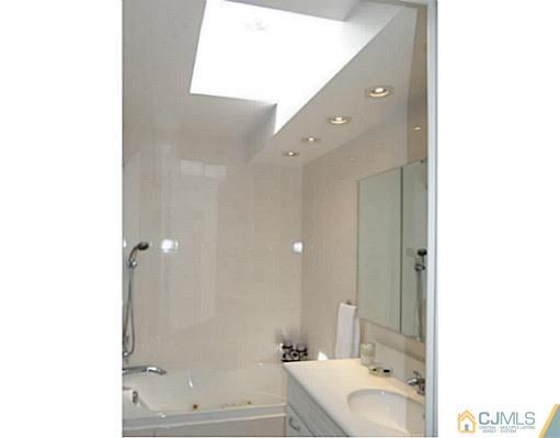 3403 Springbrook Drive Edison, NJ 08820 - Photo 20 of 24 a bathroom with a sink and a mirror