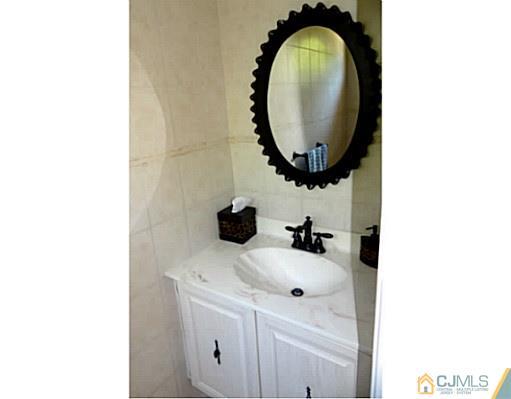 3403 Springbrook Drive Edison, NJ 08820 - Photo 10 of 24 a bathroom with a sink and a mirror