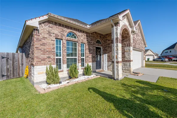 a front view of a house with a yard and porch