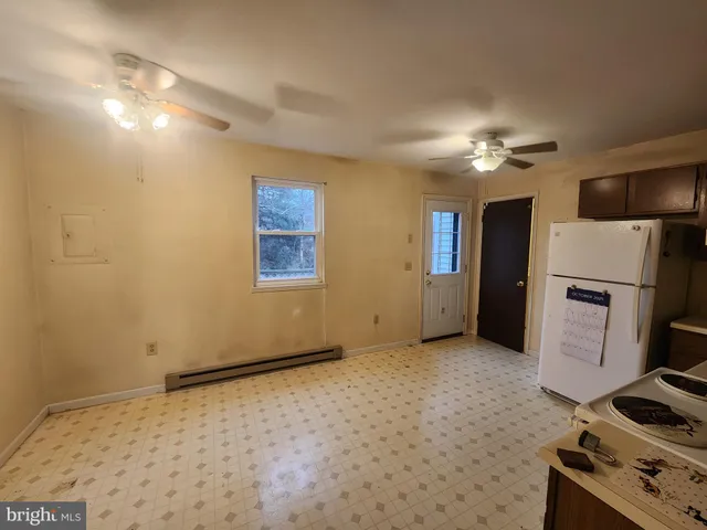 a view of an empty room with a fireplace