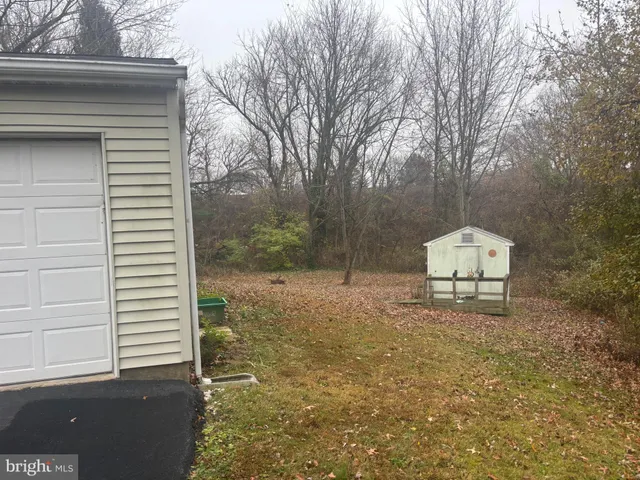 a white house that has a tree in front of it
