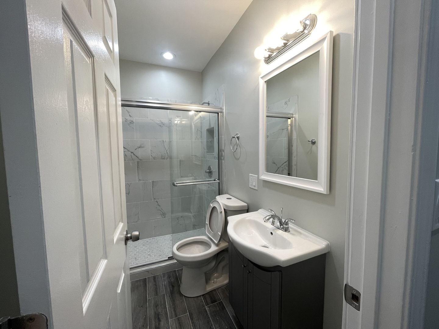 930 West 35th Street, Unit 2F Chicago, IL 60609 - Photo 2 of 13 a bathroom with a sink toilet a mirror and shower