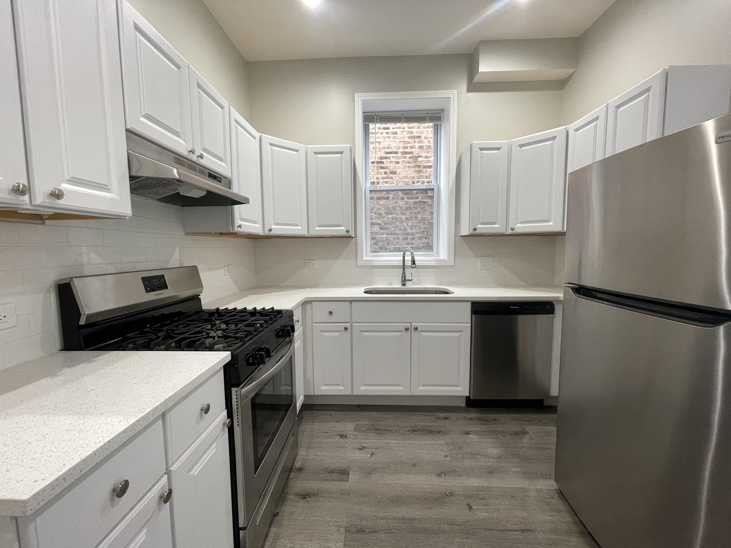 930 West 35th Street, Unit 2F Chicago, IL 60609 - Photo 4 of 13 a kitchen with a white cabinets and white appliances