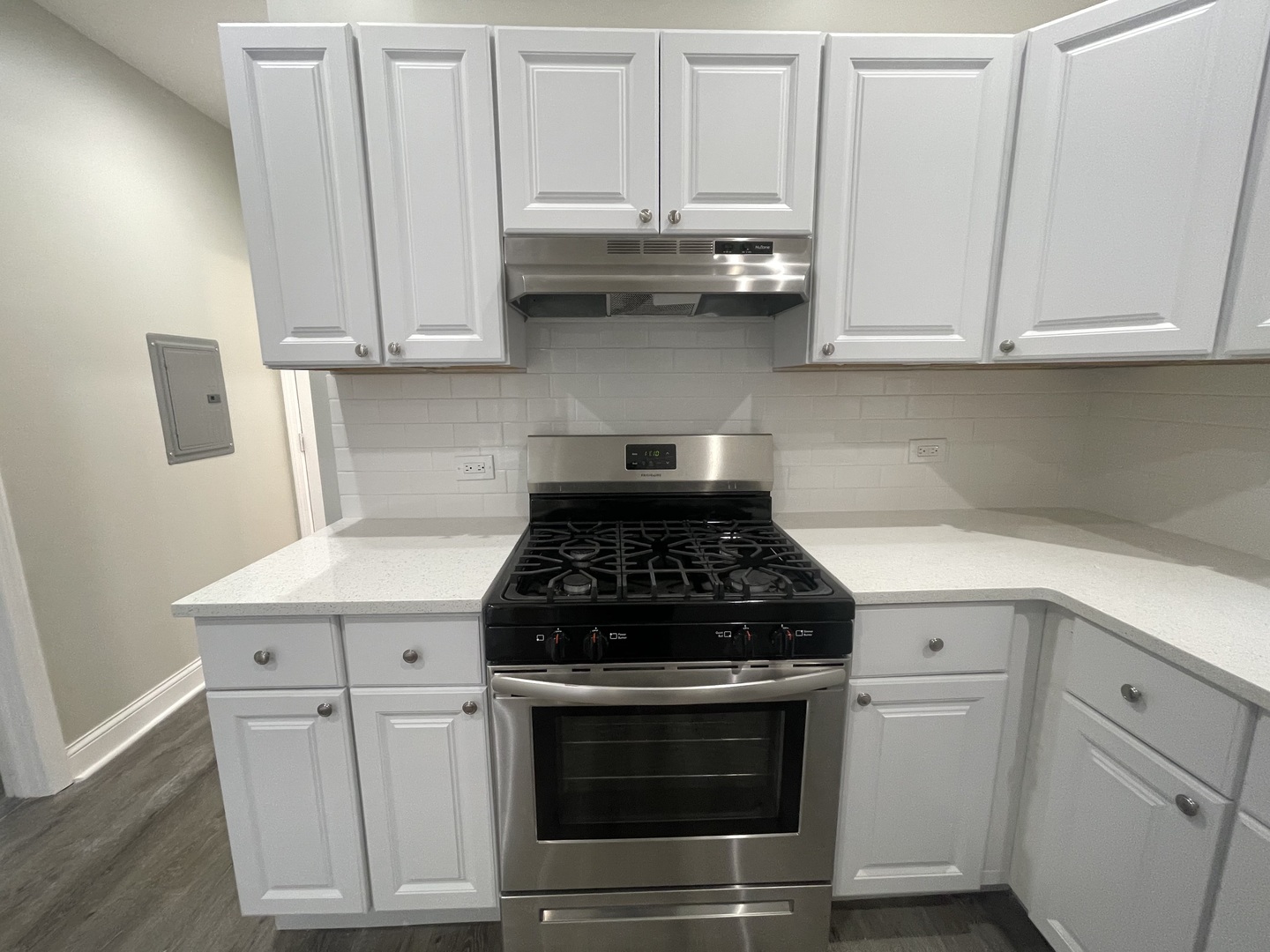 930 West 35th Street, Unit 2F Chicago, IL 60609 - Photo 5 of 13 a kitchen with granite countertop white cabinets and stainless steel appliances