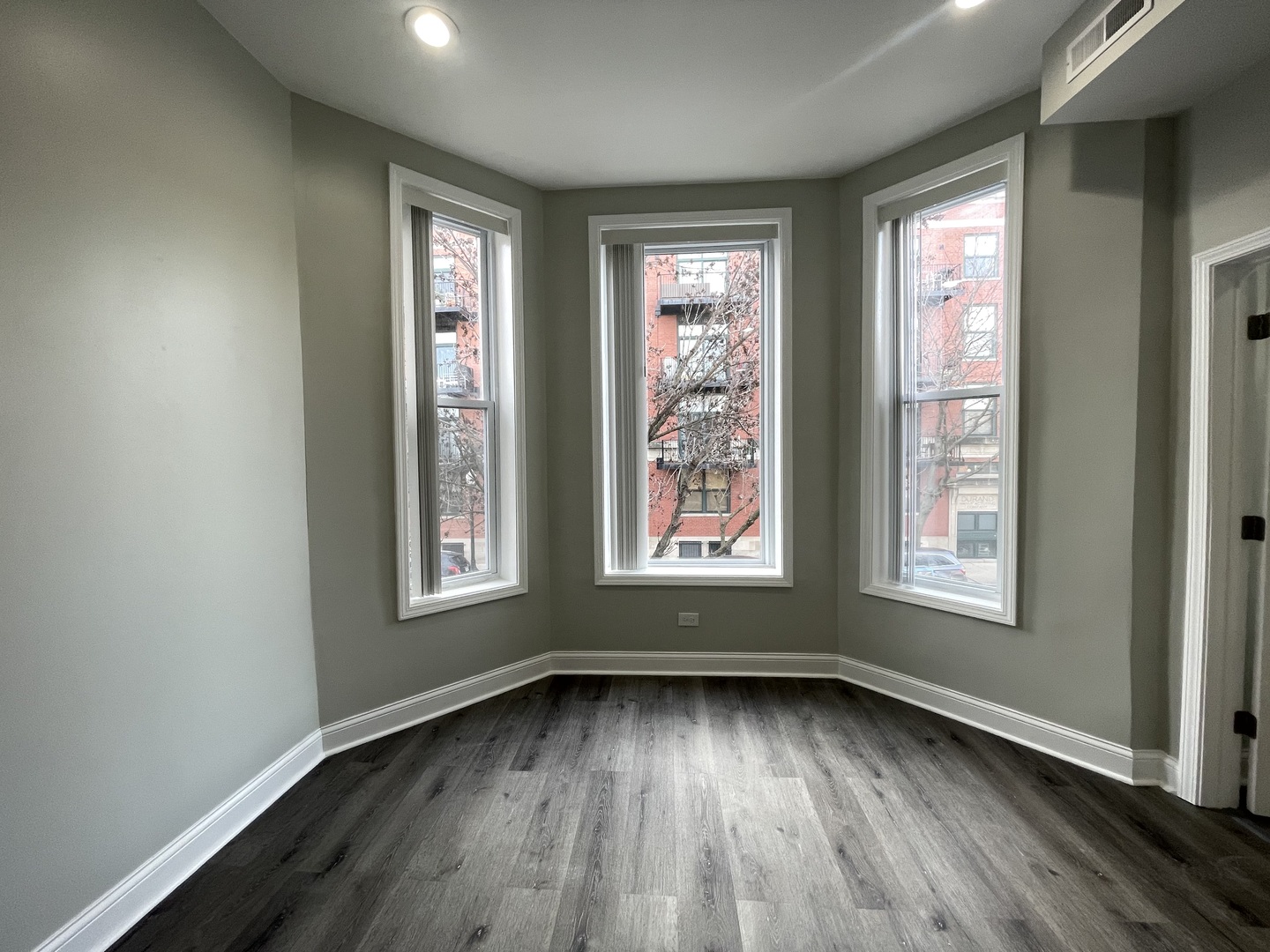 930 West 35th Street, Unit 2F Chicago, IL 60609 - Photo 7 of 13 an empty room with wooden floor and windows