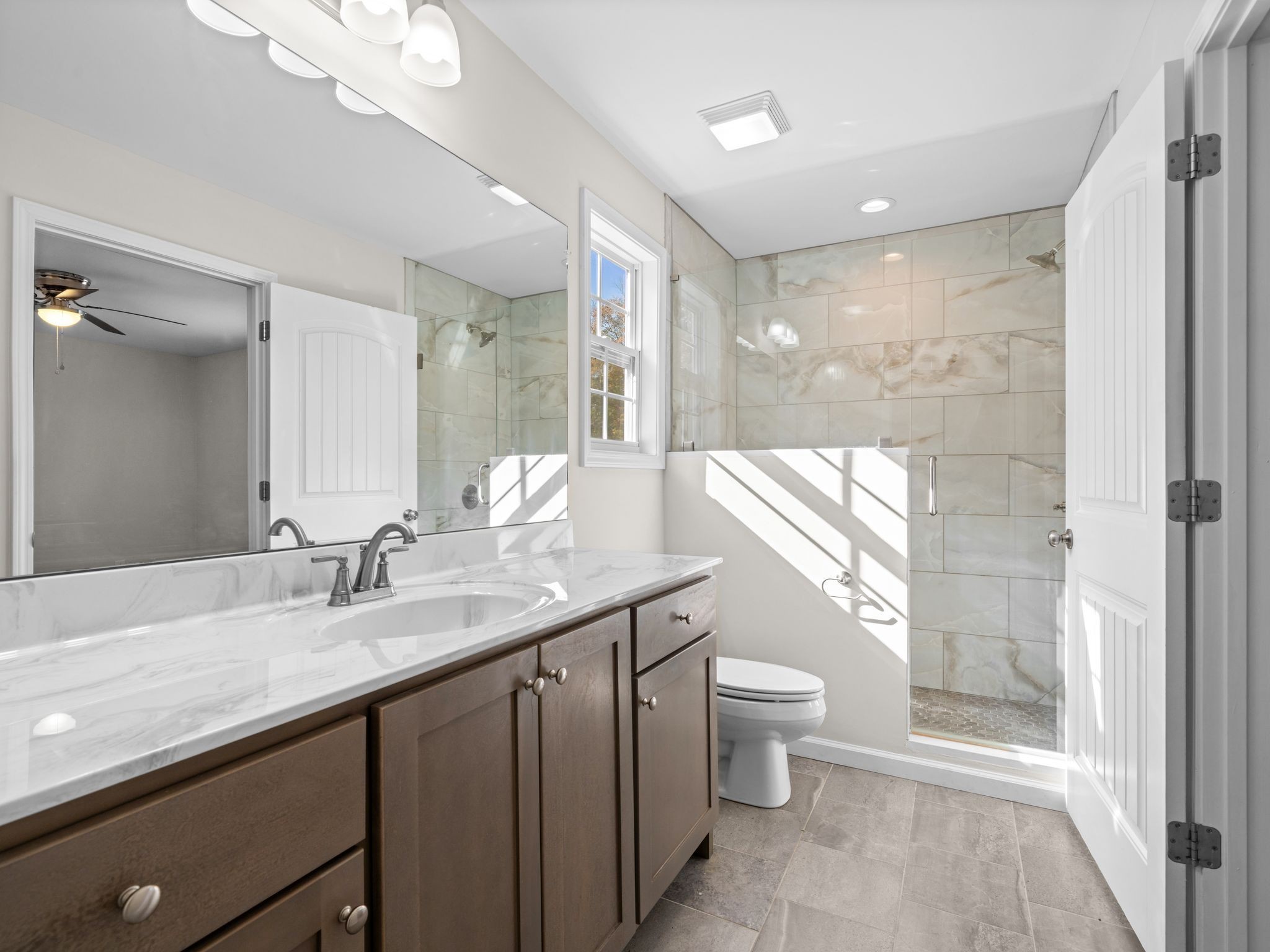 4413 Taylor Road Springfield, TN 37172 - Photo 22 of 28 a bathroom with a granite countertop sink a toilet a mirror and shower