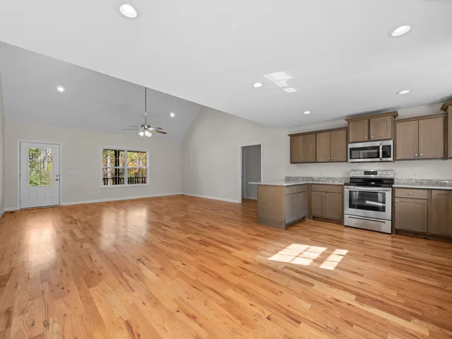 a view of kitchen with wooden floor electronic appliances and window