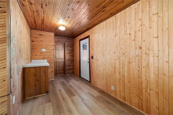 a view of a hallway with wooden floor
