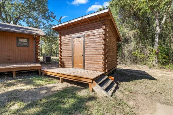 a backyard of a house with barbeque oven