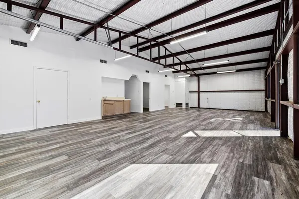a view of a room with wooden floor