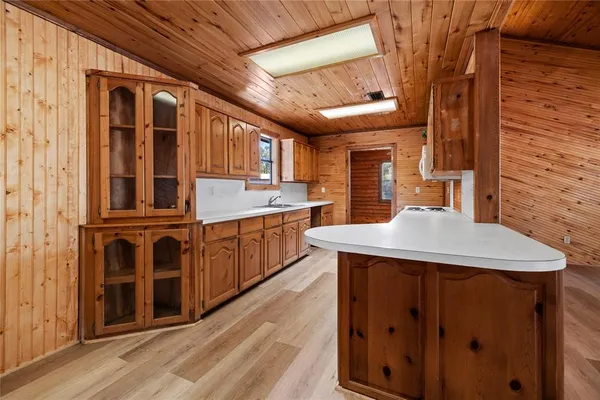 a kitchen with a stove a sink dishwasher and a refrigerator