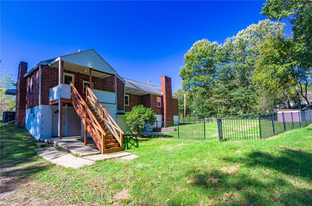 16 Engle Road Industry, PA 15052 - Photo 2 of 23 Back of home with separate entrances to either main floor (kitchen) or finished basement. Iron fence encloses part of the property, great for pets/kids. Total property is about 0.6 acres.