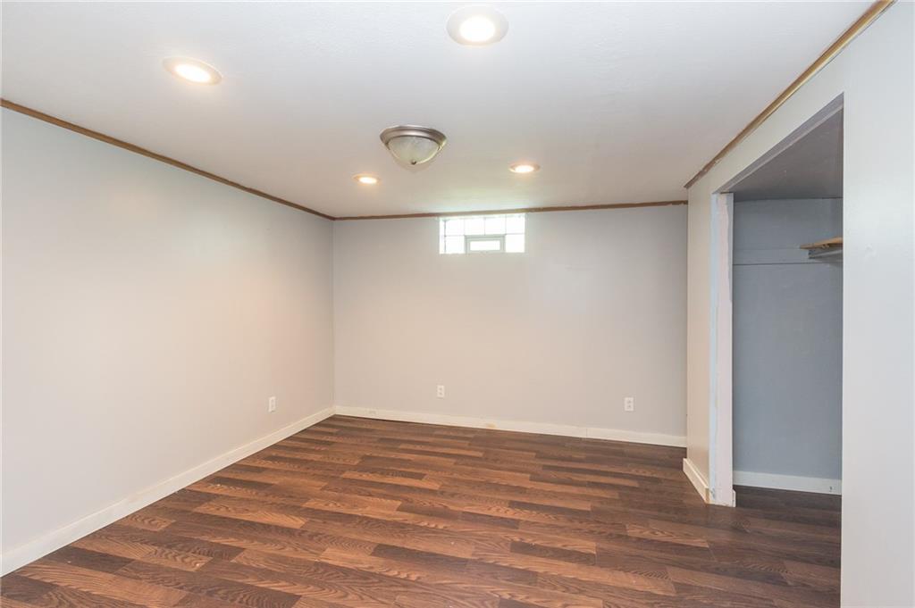 16 Engle Road Industry, PA 15052 - Photo 13 of 23 Third bedroom in basement has prego-style flooring and new paint.