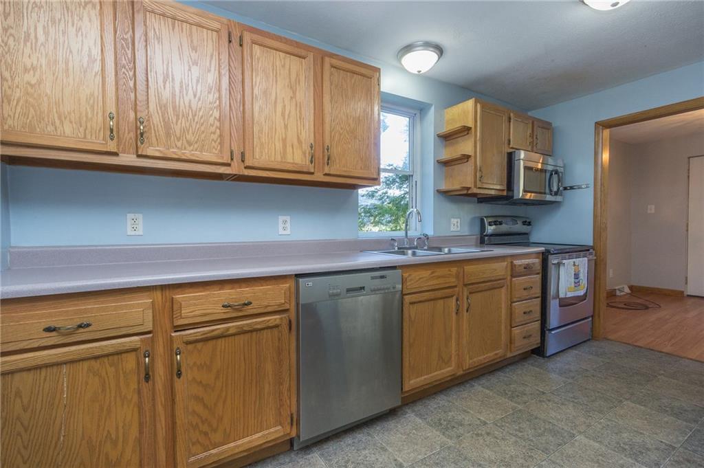 16 Engle Road Industry, PA 15052 - Photo 3 of 23 Nice size galley-style kitchen with appliances. Picture window has view of yard, private road, and local community park entrance.