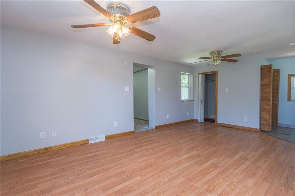 16 Engle Road Industry, PA 15052 - Photo 6 of 23 Nice new paint color for the open concept living/ dining room combination. Hallway leads to basement stairs and back of home where the bedrooms/ bath are located.