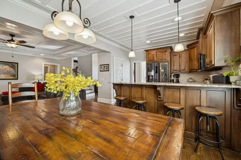 a kitchen with kitchen island granite countertop a sink cabinets and window
