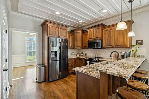 a view of a workspace with furniture and wooden floor