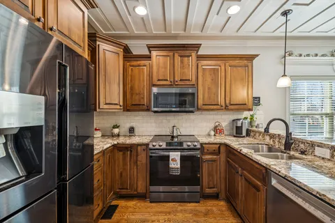 a view of a livingroom with wooden floor and a ceiling fan